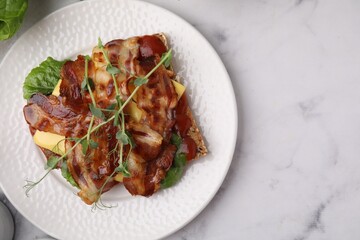 Tasty sandwich with bacon and microgreens on white marble table, top view. Space for text