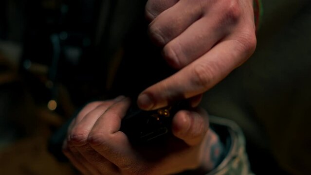 vertical video close-up at a professional shooting range military trainer loads a magazine with bullets