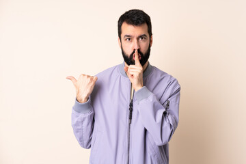 Caucasian man with beard wearing a jacket over isolated background pointing to the side and doing...
