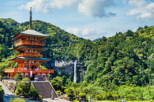 The red three-story pagoda of Seigantoji Buddhist Temple in front of Nachi Falls. Beautiful natural scenery in Nachikatsuura, Japan
