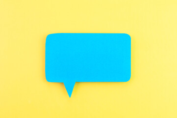 Blue speech bubble on a yellow background.