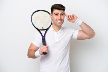 young tennis player man isolated on white background having doubts and thinking