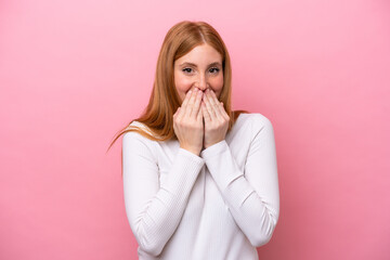 Young redhead woman isolated on pink background happy and smiling covering mouth with hands