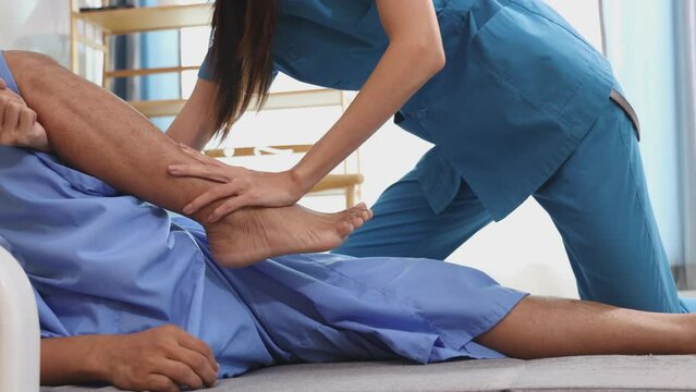Woman on physiotherapy table lying on the side. Professional physician is massaging back of women , manual therapy and osteopathy