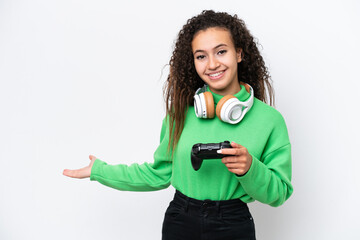 Young Arab woman playing with a video game controller isolated on white background extending hands to the side for inviting to come