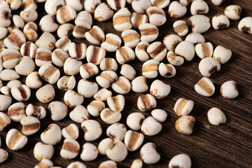 Job's tears closed up on wooden table.