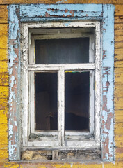 Old wooden window with peeling paint