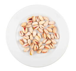 Pistachio nuts on a plate. On a white background