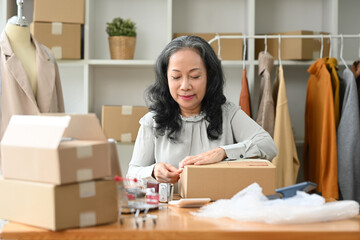 Small business owner preparing pack the boxes to customer. Business online and e-commerce concept