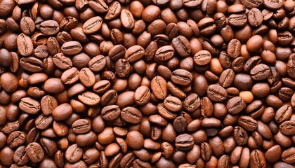 Fototapeta premium Top view background of aromatic brown coffee beans scattered on surface