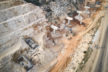 Aerial view of highway ledges under construction after drilling and blasting operations. Road...