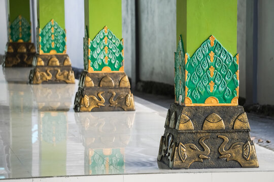 Carvings or ornaments on the green pillars of traditional Javanese buildings in Indonesia. Concept for Javanese Architecture