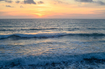 Warm waves of the Mediterranean sea and a sandy beach at sunrise 1