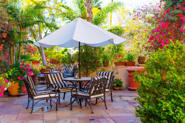 Elegant Outdoor Patio Dining Set Amidst Lush Garden Blooms