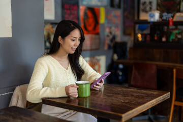 Woman use of mobile phone in cafe