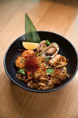 Top view on pretty decorated tasty and fresh seafood ramen meal