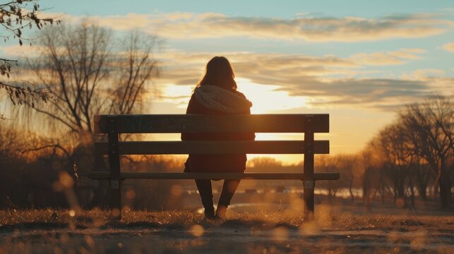 A woman sitting alone on a bench
