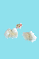 Cute plasticine sheep jumping on the clouds.