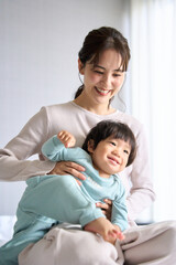 ベッドで触れ合う母と1歳10ヶ月の息子