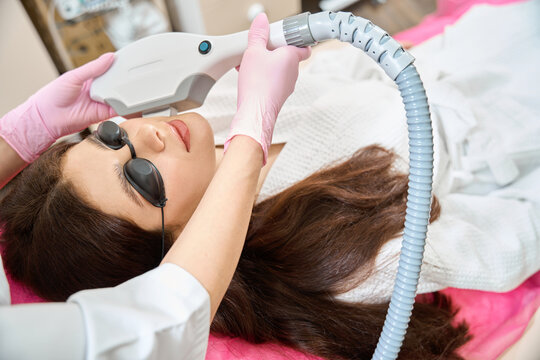 Medicine clinic client undergoing IPL photofacial conducted by professional