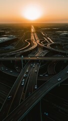 Fototapeta premium Urban Highway Interchange at Sunset with Busy Traffic and Skyscrapers