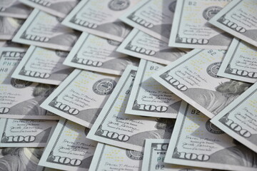 Processed collage of many US hundred dollar bills banknotes texture. Background for banner