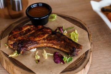 Pork steak with sauce on a wooden board