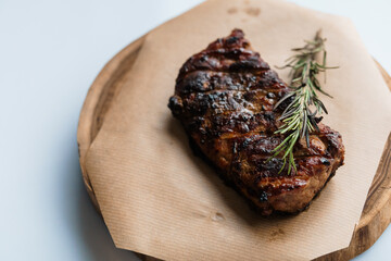 Pork steak with sauce on a wooden board