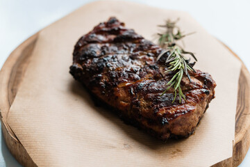 Pork steak with sauce on a wooden board
