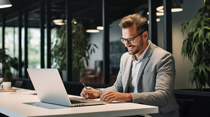 Fototapeta premium Smiling Businessman Working on Laptop in Modern Office