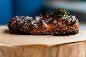 Pork steak with sauce on a wooden board