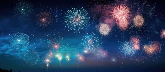 Fototapeta premium A breathtaking display of artificial fireworks illuminating the night sky surrounded by darkness with ample copy space for an image