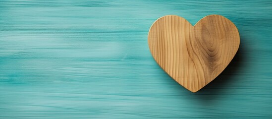 A turquoise background hosts a wooden heart with the inscription I love you providing ample space for personalization
