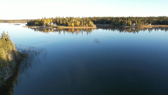 Aerial Drone Video of Emma Lake, SK in Autumn - Vibrant Fall Colors, Scenic Lake Views, and Forests