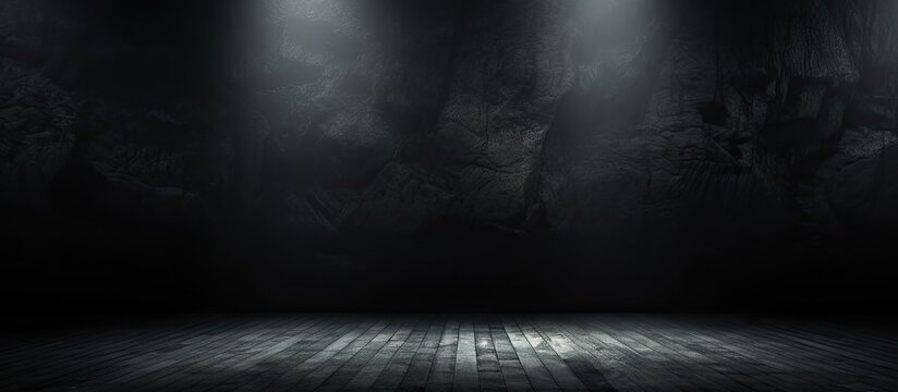 A dark toned background with a spotlight illuminating a black paper texture or backdrop creating a dramatic atmosphere Perfect for copy space images or wallpapers with a dark wall aesthetic