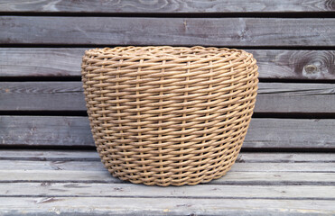 Wicker flower pots on a wooden bench