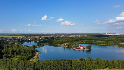 Scenic Aerial View of Lake Surrounded by Fields, Forests, and Buildings in Minsk, Belarus, Europe