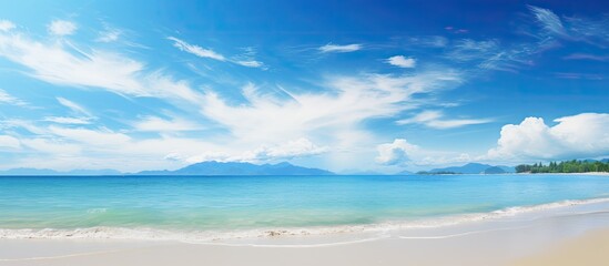Obraz premium Copy space image of a serene beach with a vivid blue sky in the background
