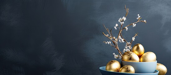 Stylish Easter golden decorated eggs on grey plate isolated on blue background Trendy flat lay easter Happy Easter card with copy space for text Minimal easter concept