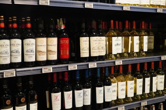 Bucharest, Romania - May 23, 2024: Red and white wine bottles displayed on shelves in hypermarket