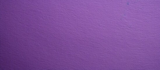 Close up image of a textured purple paper background with space for copying