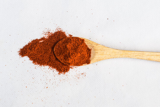red chilli  in spoon, Pile of red paprika powder in wooden spoon isolated on white, top view, Mixture of Indian Spices and Herbs Powders with Cumin, Curry, Curcuma, Turmeric and Chilli Pepper. Orange 