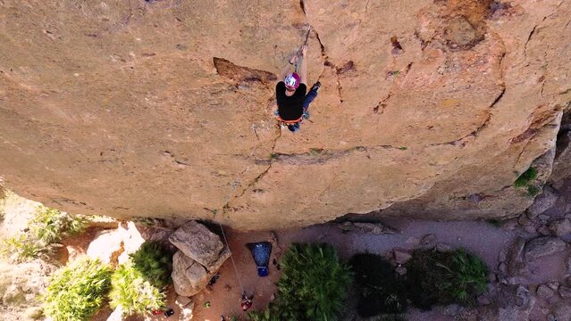 Sportsman rock climbing aerial view of sportsman rapelling mountain in La Panocha, el Valle Murcia, Spain woman rapel down a mountain climbing a big rock