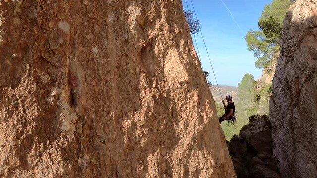 Sportsman rock climbing aerial view of sportsman rapelling mountain in La Panocha, el Valle Murcia, Spain woman rapel down a mountain climbing a big rock