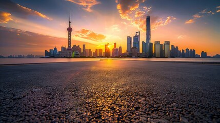 Naklejka premium Photograph of an empty asphalt road and city skyline with buildings at sunset in Shanghai.