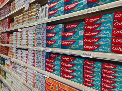 Toothpaste brands on shelves at supermarket aisle