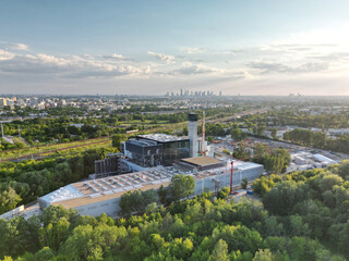 Modern waste incineration plant, metropolitan skyscrapers in the background, low-emission...