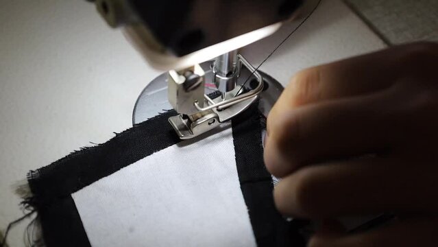 Close-up video, the process of sewing or combining clothing components that have been cut into clothes in a clothing factory. 