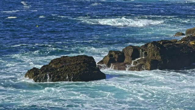 Rocky coastline with dinamic waves