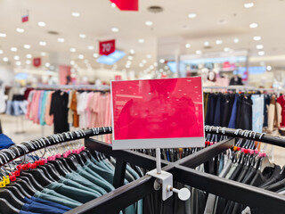 empty red board on clothes hanger display. mockup for promotions and discounts. 